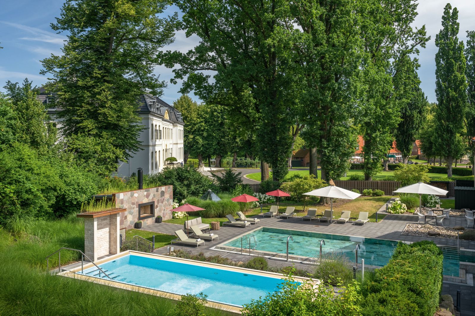 Image may contain Pool Water Swimming Pool Outdoors Nature Scenery Backyard Yard Architecture Building and Chair