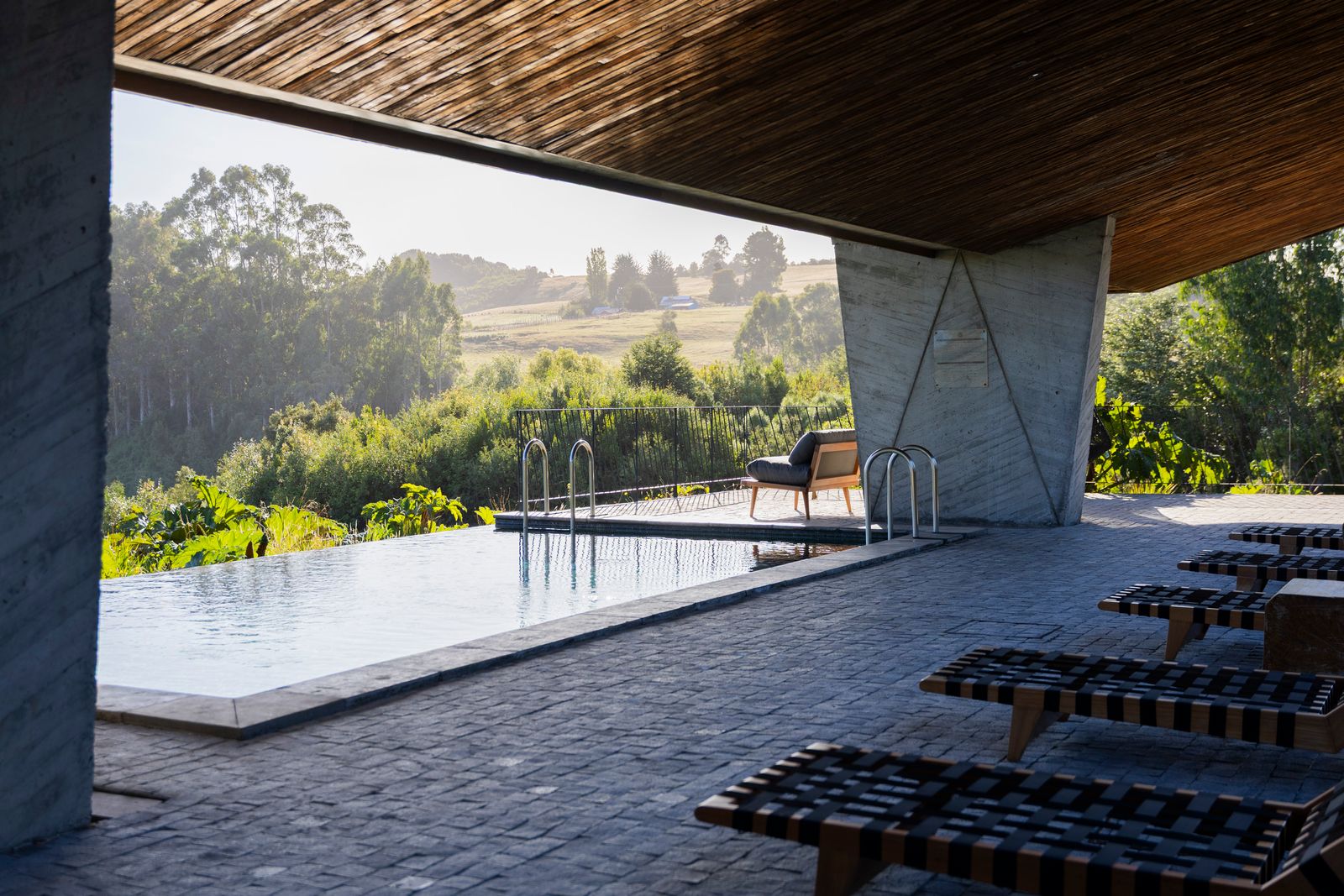 Image may contain Nature Outdoors Scenery Indoors Interior Design Pool Water Chair Furniture and Swimming Pool