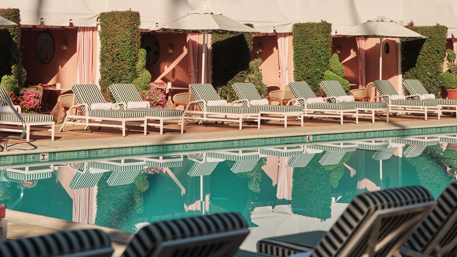 Image may contain Pool Water Swimming Pool Architecture Building Hotel Resort Furniture Chair and Outdoors