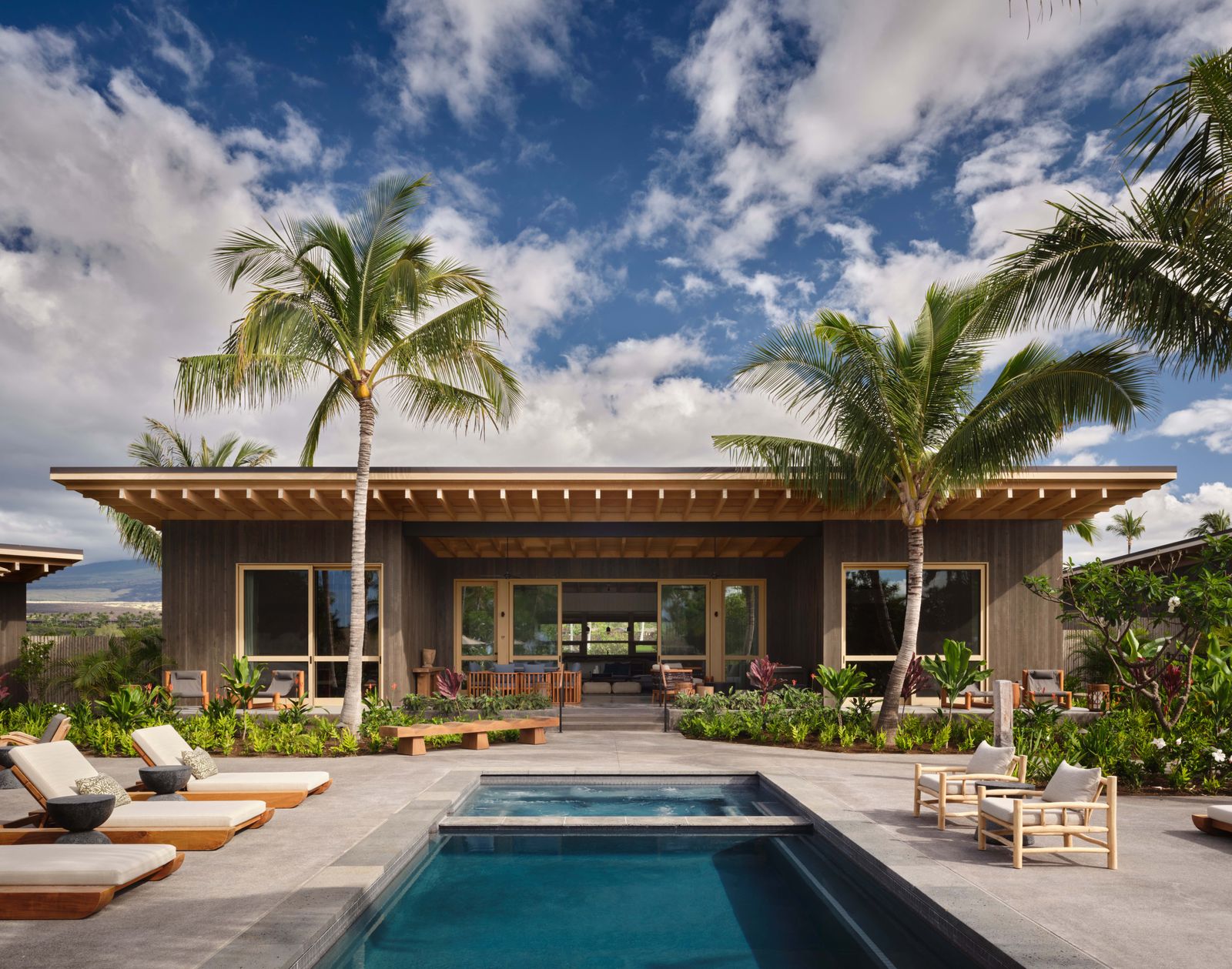 Image may contain Architecture Building House Housing Villa Pool Water Swimming Pool Hotel Chair and Furniture