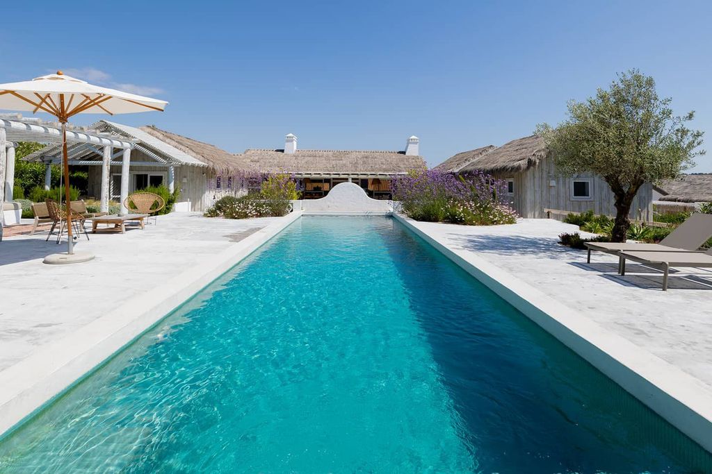 Image may contain Pool Water Swimming Pool Architecture Building House Housing Villa Outdoors and Aerial View