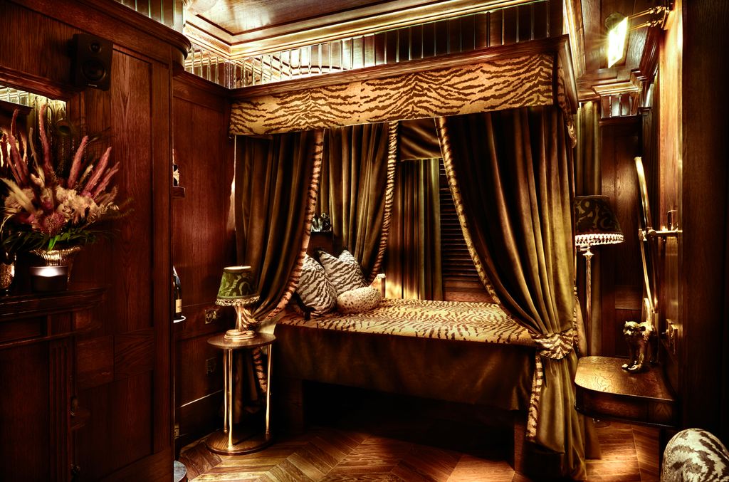 Image may contain Furniture Indoors Bed Bedroom Room Lamp Interior Design Electronics and Speaker