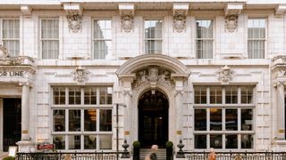 Image may contain City Plant Person Urban Accessories Bag Handbag Architecture Building Housing and Walking