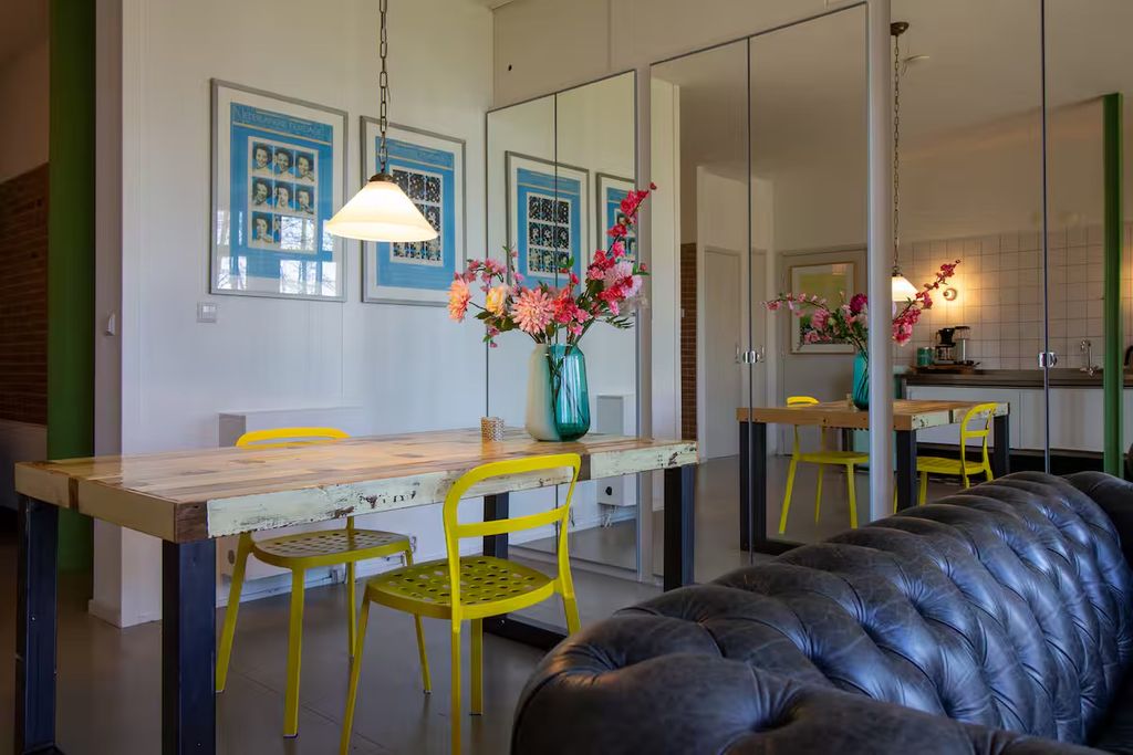 Image may contain Flower Flower Arrangement Plant Indoors Interior Design Dining Table Furniture and Table