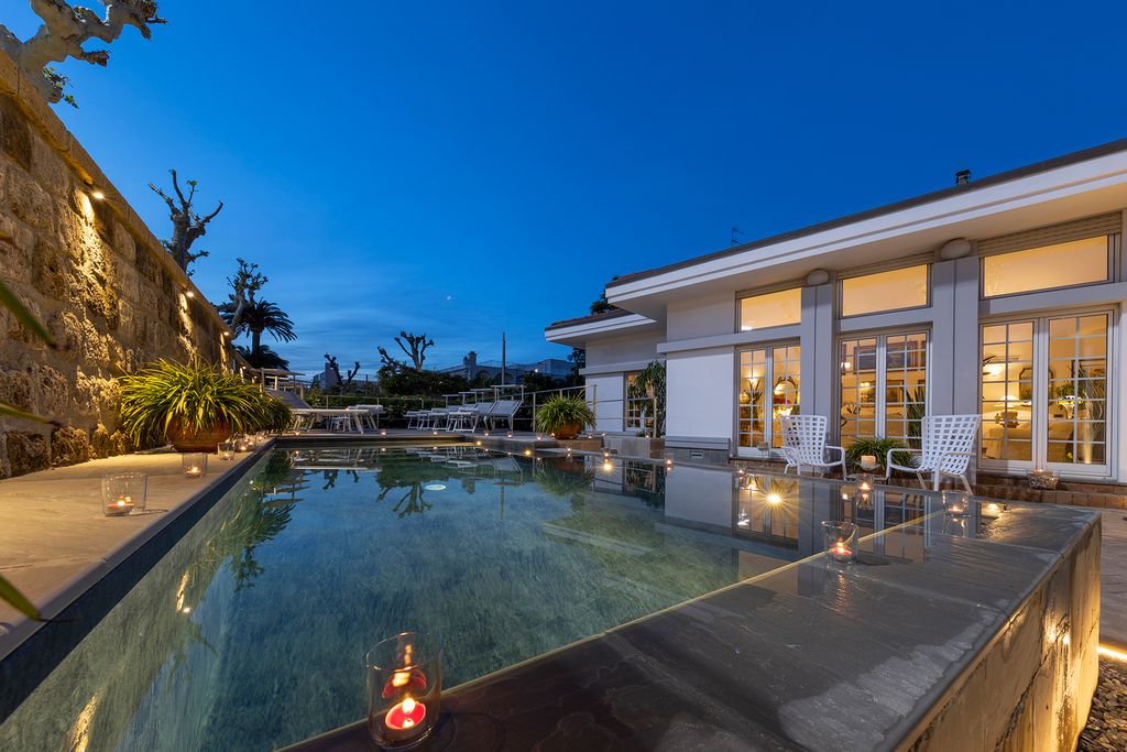 Image may contain Pool Water Architecture Building Hotel Resort House Housing Villa Swimming Pool and Candle